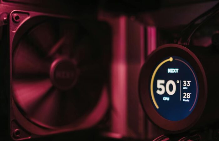 Close-up of a PC cooling system and motherboard, highlighting digital temperature display.